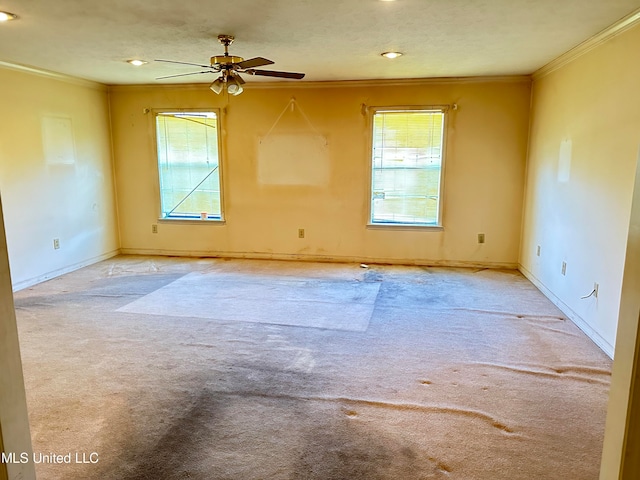 unfurnished room with ceiling fan, ornamental molding, and light colored carpet