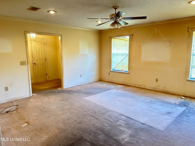 unfurnished room with crown molding, light carpet, and ceiling fan