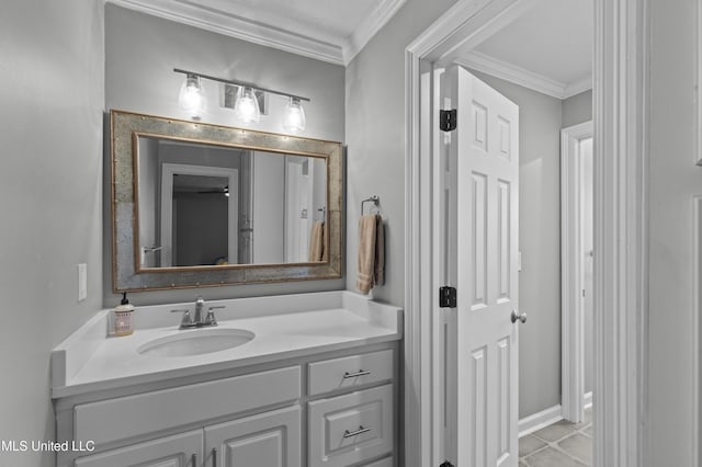 bathroom with tile patterned flooring, crown molding, and vanity