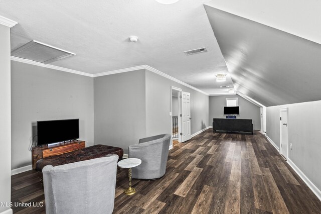 interior space featuring attic access, baseboards, visible vents, dark wood finished floors, and crown molding