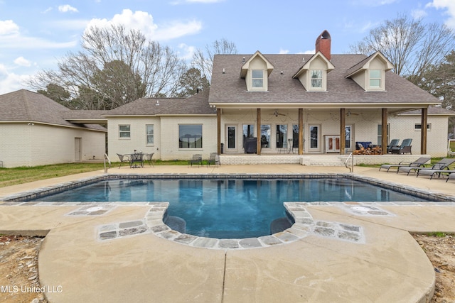 outdoor pool featuring ceiling fan and a patio area