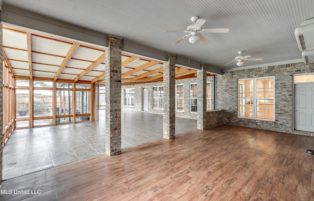121 Poplar Ridge Dr, Brandon, MS 39047 - spare room with a ceiling fan, brick wall, healthy amount of natural light, and wood finished floors