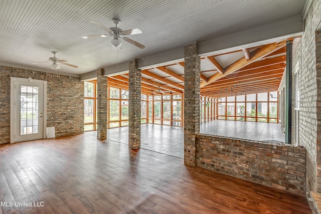121 Poplar Ridge Dr, Brandon, MS 39047 - empty room featuring ceiling fan, brick wall, wood finished floors, and ornate columns