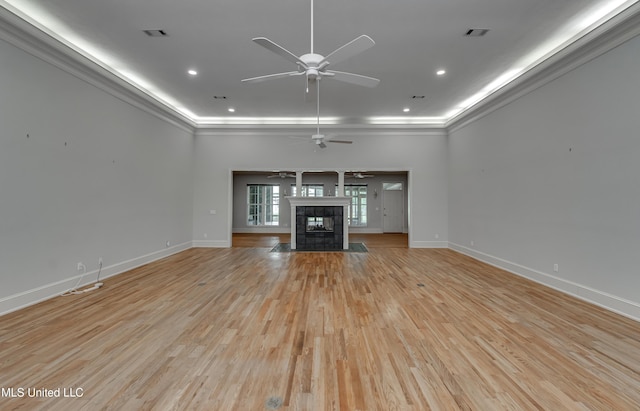 121 Poplar Ridge Dr, Brandon, MS 39047 - unfurnished living room featuring ornamental molding, baseboards, a ceiling fan, light wood-type flooring, and a fireplace
