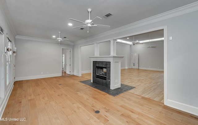 121 Poplar Ridge Dr, Brandon, MS 39047 - unfurnished living room with a ceiling fan, ornamental molding, light wood-type flooring, a tile fireplace, and baseboards