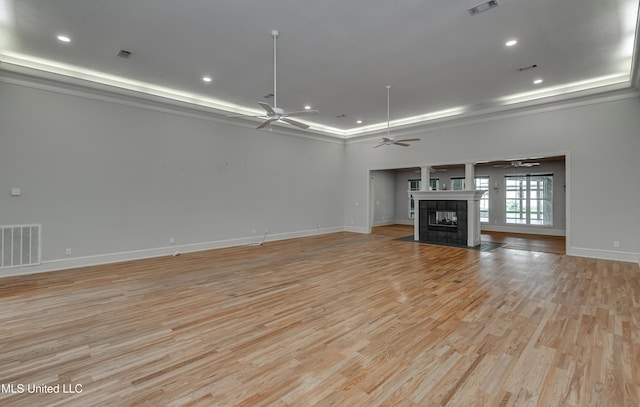 121 Poplar Ridge Dr, Brandon, MS 39047 - unfurnished living room with a ceiling fan, a raised ceiling, baseboards, light wood-style floors, and recessed lighting
