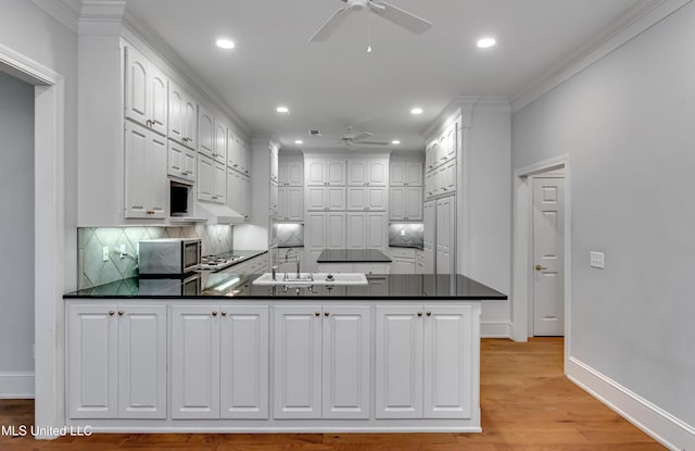 121 Poplar Ridge Dr, Brandon, MS 39047 - kitchen with a ceiling fan, appliances with stainless steel finishes, a peninsula, a sink, and recessed lighting