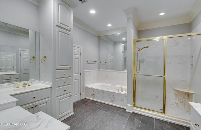 121 Poplar Ridge Dr, Brandon, MS 39047 - full bathroom featuring vanity, a garden tub, a marble finish shower, crown molding, and recessed lighting