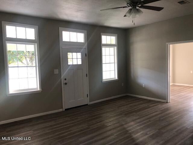 foyer entrance with ceiling fan and dark hardwood / wood-style floors