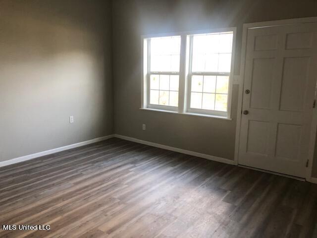 spare room with dark hardwood / wood-style floors