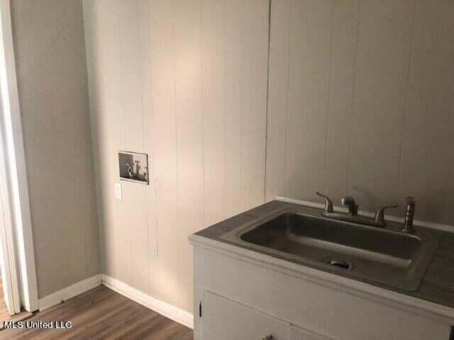 washroom with dark hardwood / wood-style floors and sink