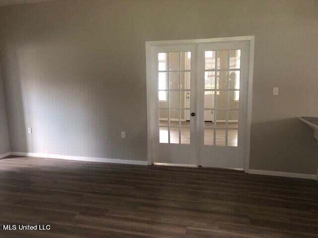 doorway with dark hardwood / wood-style flooring and french doors