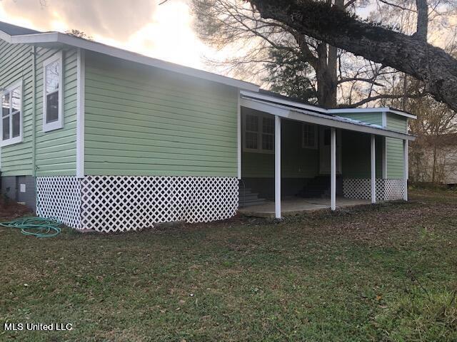 property exterior at dusk with a yard