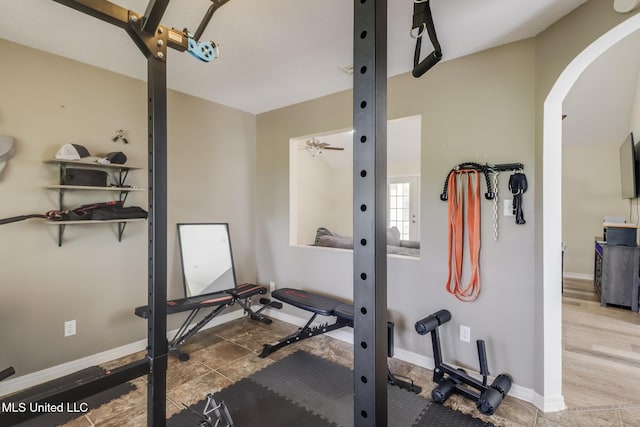 workout area featuring arched walkways and baseboards
