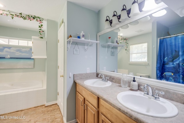 bathroom with a garden tub and double vanity