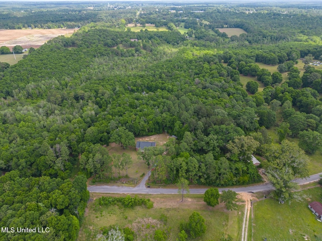 view of property location with a heavily wooded area