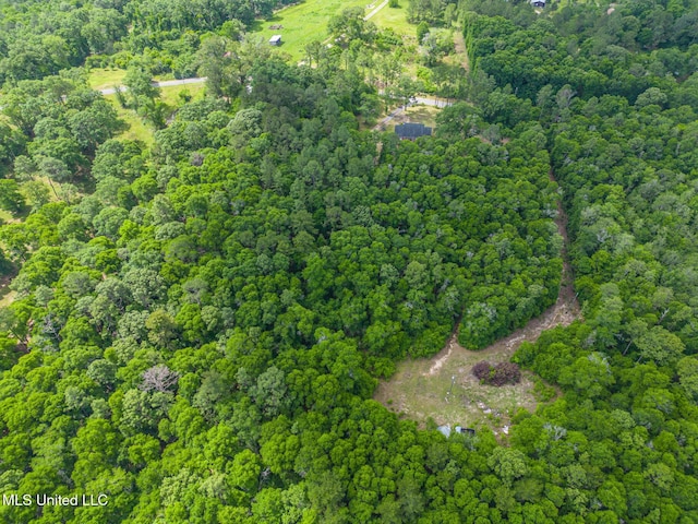 aerial view of property and surrounding area with a forest