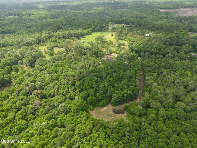 aerial view of property's location with a heavily wooded area