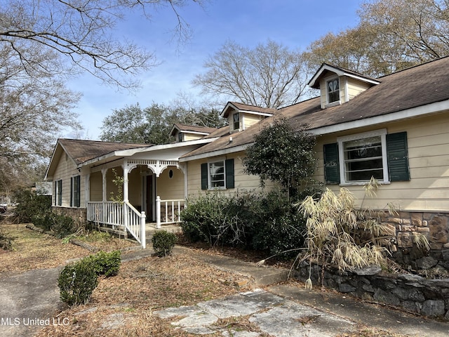 view of property exterior featuring covered porch