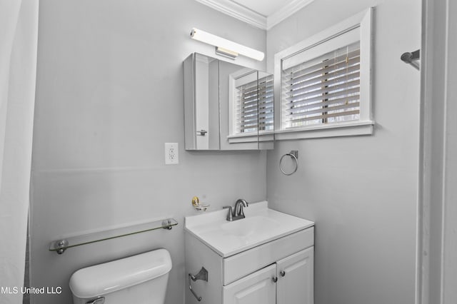 bathroom featuring toilet, crown molding, and vanity