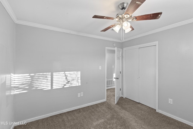 unfurnished bedroom featuring ornamental molding, carpet flooring, visible vents, and baseboards