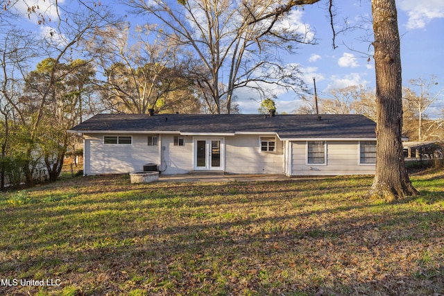 view of front facade with a front yard, french doors, and a patio area