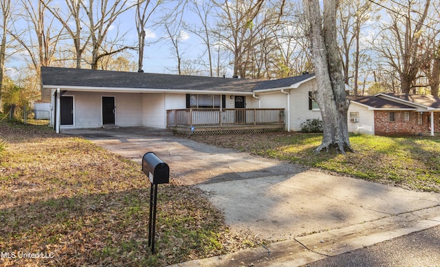 single story home featuring concrete driveway and brick siding