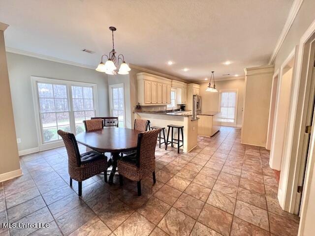 dining area featuring a notable chandelier and crown molding