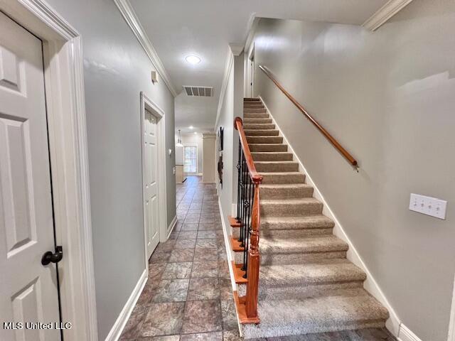 staircase with crown molding