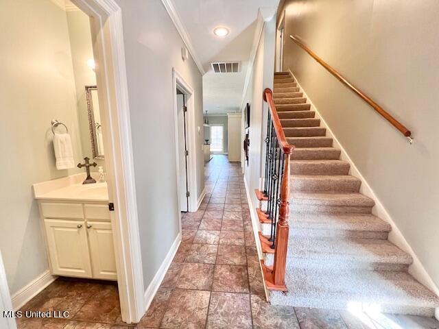 stairway with sink and ornamental molding