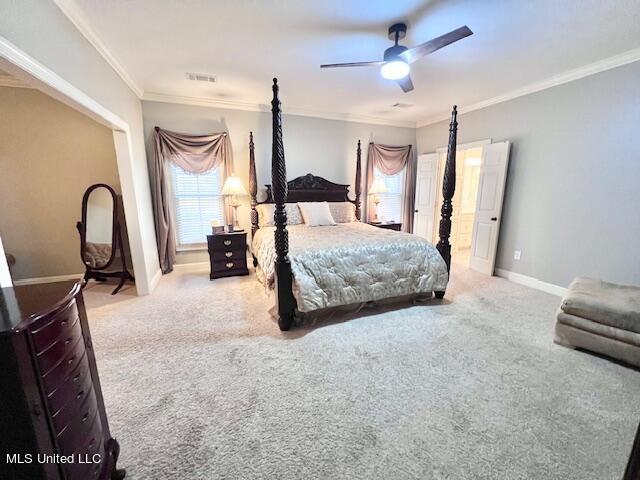 carpeted bedroom featuring crown molding and ceiling fan