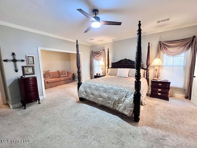 bedroom with ceiling fan, ornamental molding, and light carpet