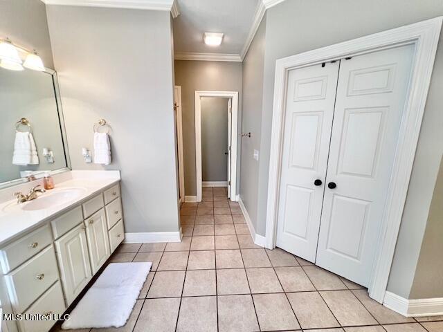 bathroom with vanity, crown molding, and tile patterned floors