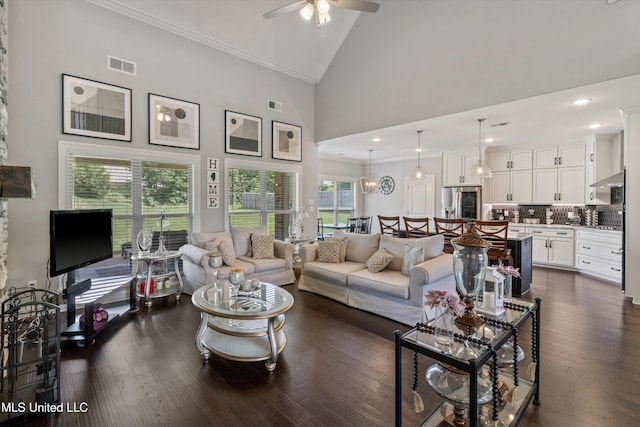 living room with crown molding, visible vents, a ceiling fan, and high vaulted ceiling
