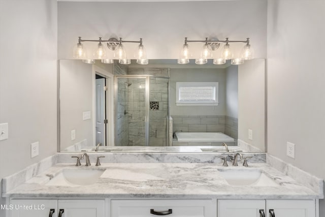 bathroom with a sink, double vanity, a stall shower, and a bath