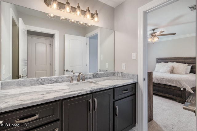 bathroom with ceiling fan, ornamental molding, visible vents, and vanity