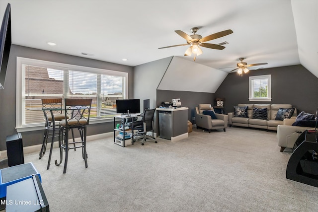 interior space with lofted ceiling, visible vents, carpet floors, a ceiling fan, and baseboards