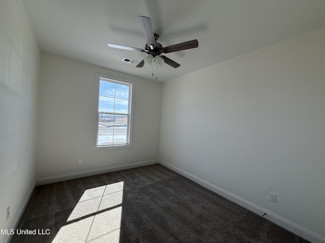 empty room with ceiling fan, baseboards, visible vents, and dark colored carpet