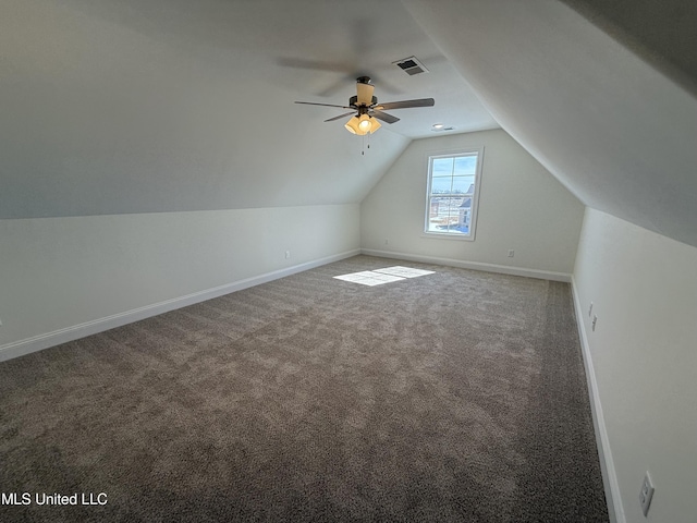 bonus room with carpet floors, a ceiling fan, visible vents, vaulted ceiling, and baseboards