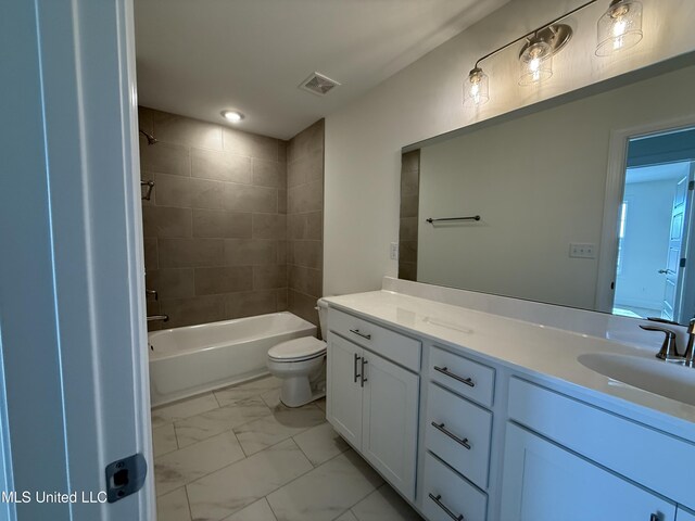 bathroom featuring marble finish floor, bathing tub / shower combination, double vanity, visible vents, and a sink