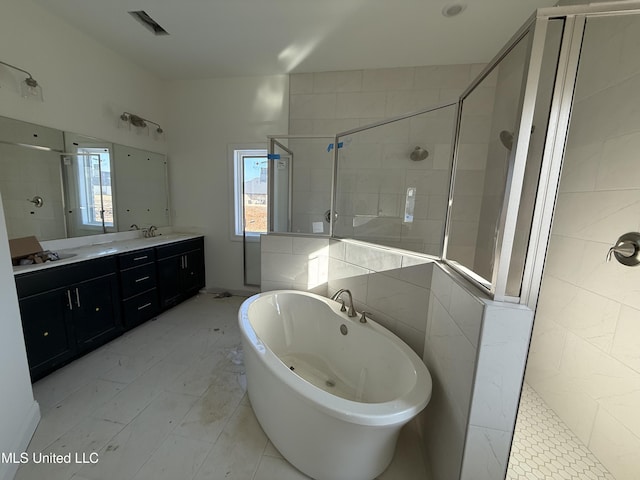 bathroom with a sink, visible vents, a freestanding bath, a shower stall, and double vanity