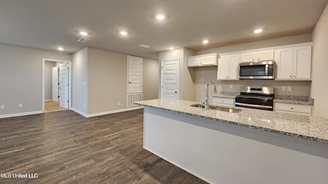 kitchen featuring recessed lighting, a sink, white cabinetry, and appliances with stainless steel finishes