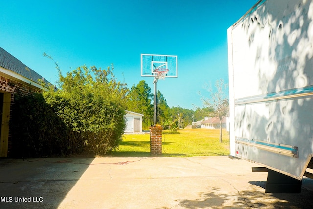 view of basketball court featuring a lawn