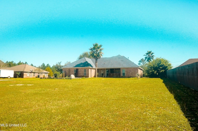 exterior space with a lawn and fence