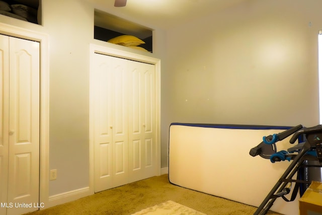 bedroom with carpet flooring and baseboards