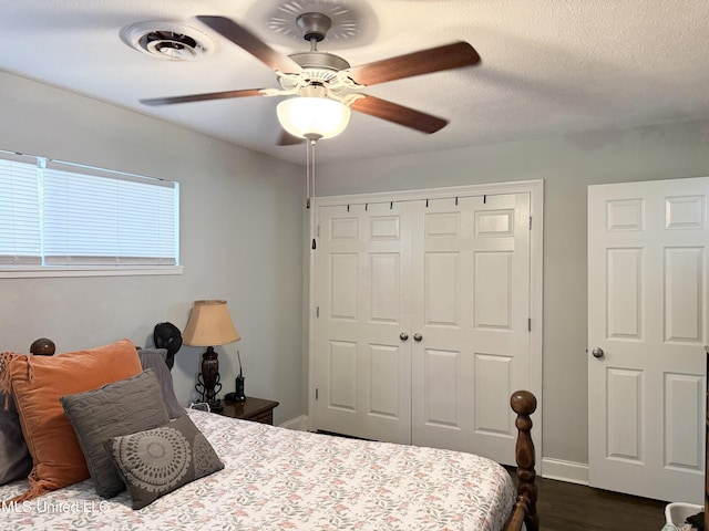 5064 Old Canton Rd, Jackson, MS 39211 - bedroom featuring visible vents, ceiling fan, a closet, a textured ceiling, and dark wood-style flooring