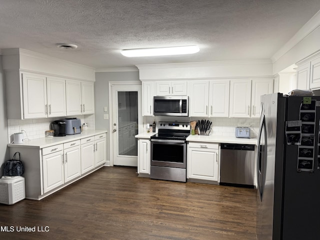 5064 Old Canton Rd, Jackson, MS 39211 - kitchen featuring backsplash, dark wood-style floors, white cabinetry, stainless steel appliances, and light countertops