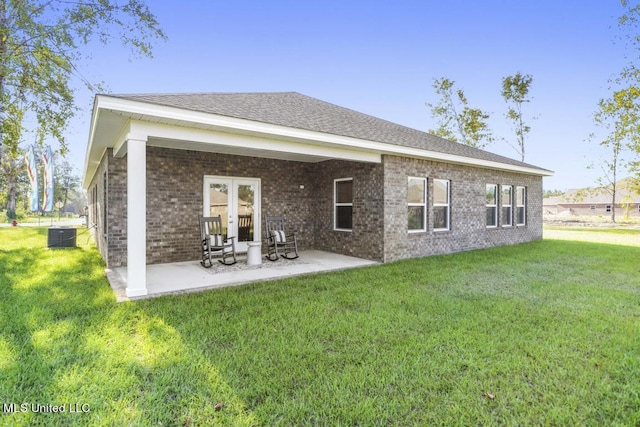 back of house with a patio, central air condition unit, and a lawn