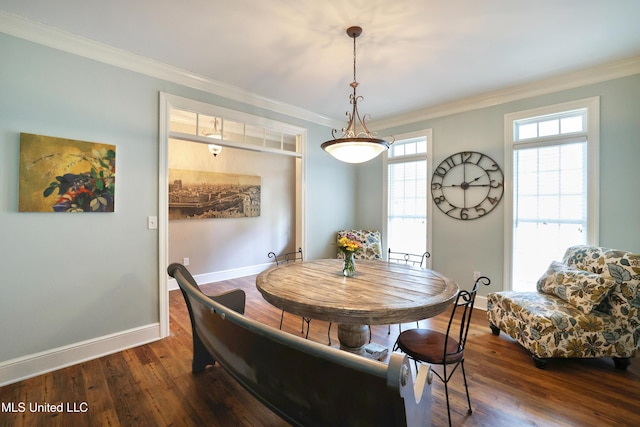 dining area featuring crown molding, baseboards, and dark wood-style flooring