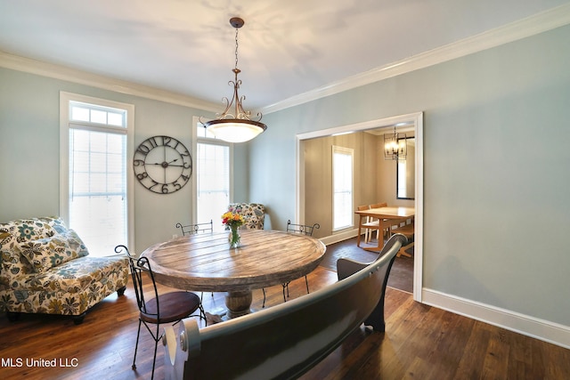 dining area with baseboards, a notable chandelier, crown molding, and hardwood / wood-style flooring